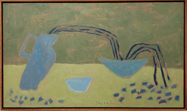 Framed abstract artwork with blue and brown elements on a white wall