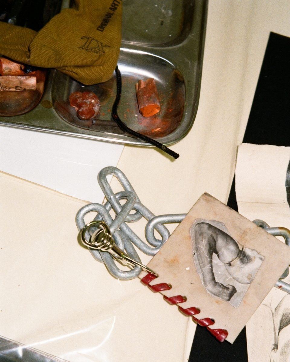 Detail shot of Ailsa Ogden’s studio showing artist’s chalk and a small contemporary print on a work surface for Partnership Editions.