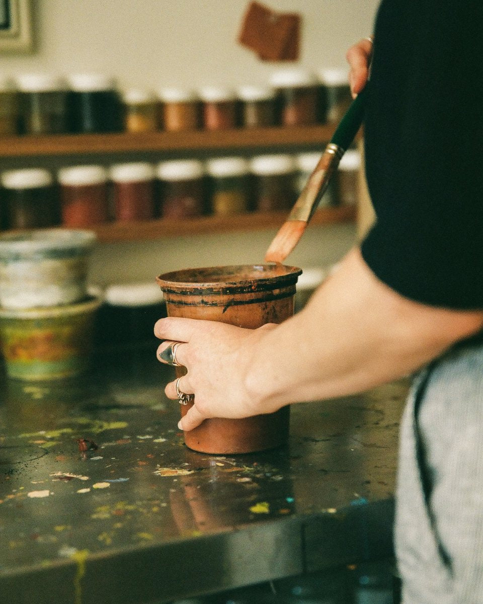 Carousel studio image of artist Alina Welch mixing and creating custom paint for her artworks for Partnership Editions.