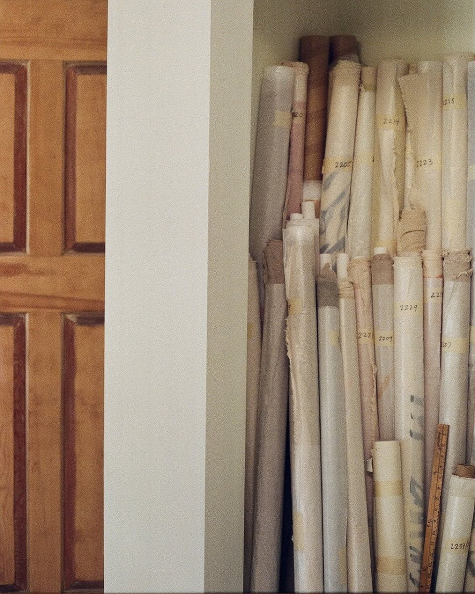 Carousel image of a collection of rolled-up, numbered canvases by artist Alina Welch in her studio for Partnership Editions.
