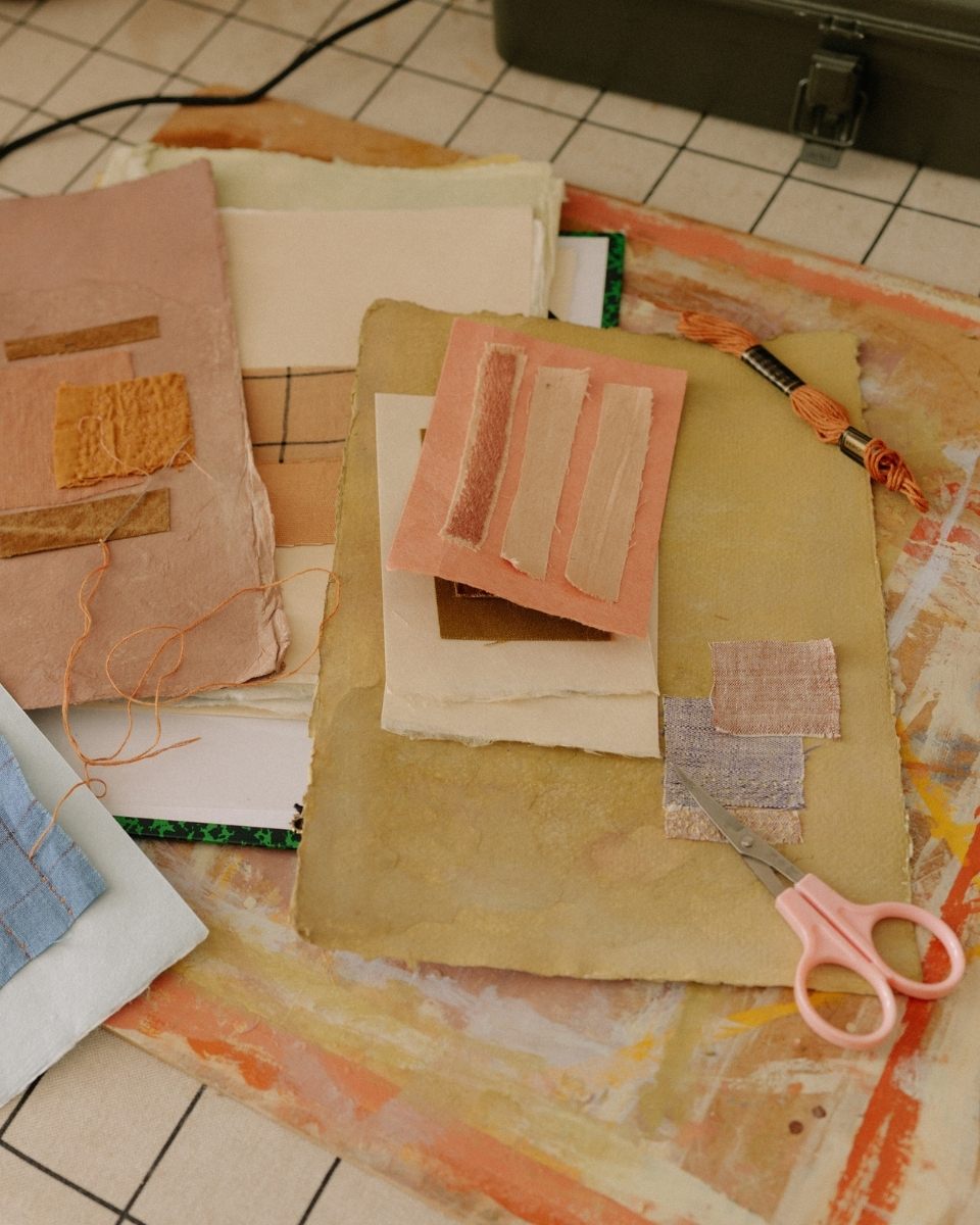 Carousel image of Ann-Marie Williamson’s studio process showing scissors, thread, and paper for her contemporary collage work at Partnership Editions.
