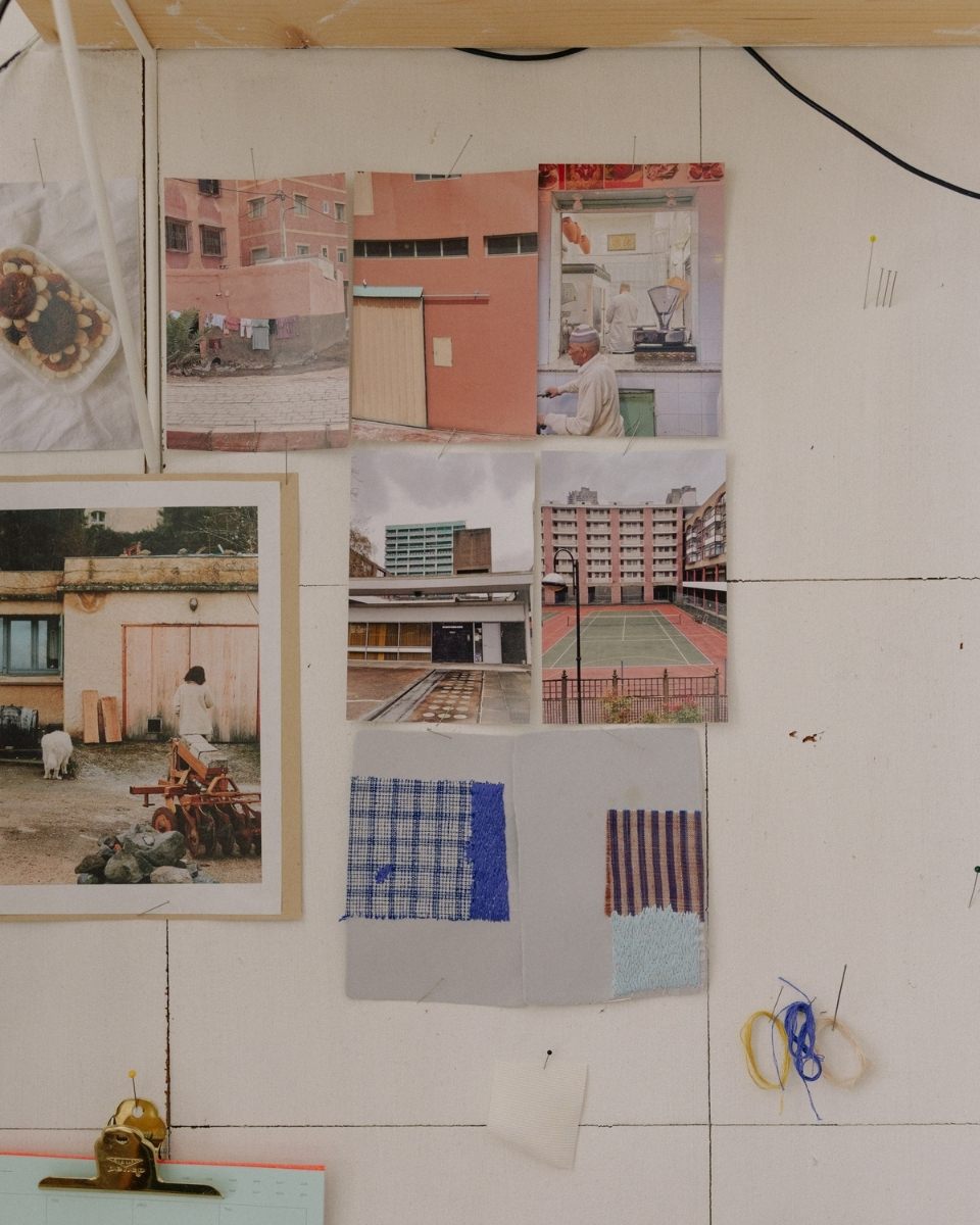 Ann-Marie Williamson’s studio wall showcasing photographic reference images, colorful threads, and textiles.