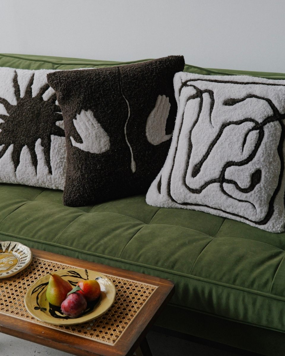 Lifestyle carousel image of finished contemporary tufted pillows by Bec Kirby displayed on a sofa for Partnership Editions.