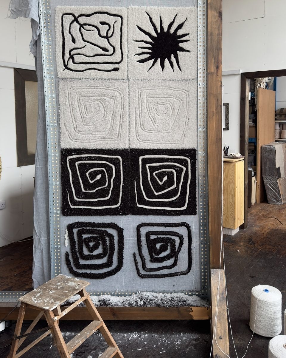 Carousel image showing the tufting studio progress and textile machinery used by Bec Kirby for Partnership Editions.