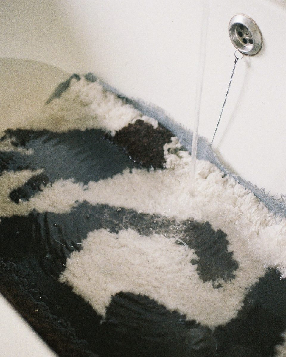 Detail shot of the wool rinsing process in Bec Kirby’s studio, highlighting the handmade nature of her textiles for Partnership Editions.