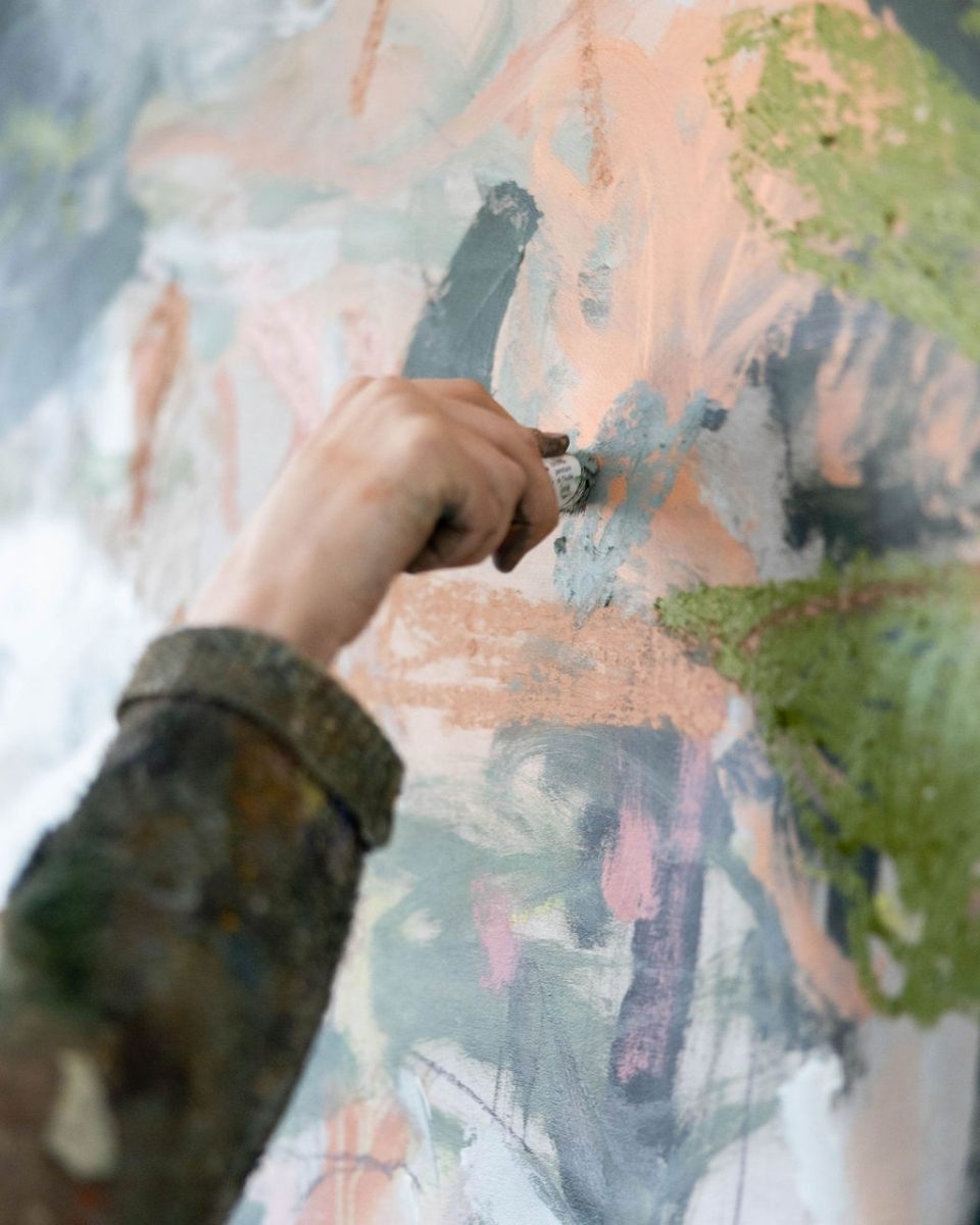 Action shot of artist Bethany Holmes applying chalk detail to a new artwork in her studio for Partnership Editions.
