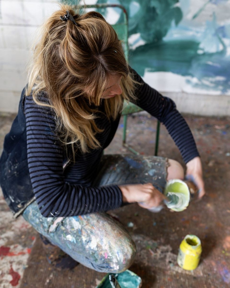 Carousel image of Bethany Holmes mixing custom paint colours in her studio for her contemporary artworks at Partnership Editions.