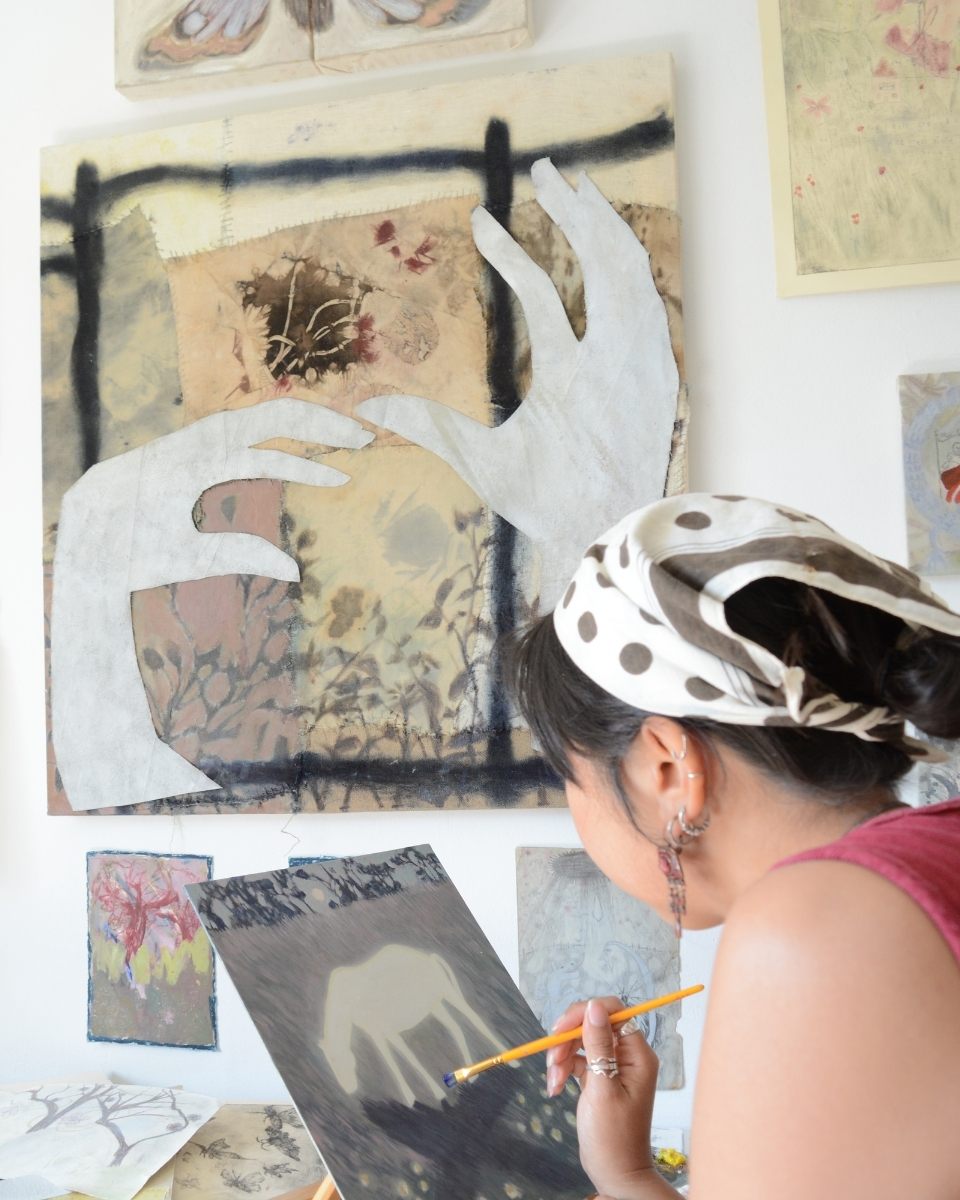 Carousel image of contemporary artist Bethenie Carriaga in her studio painting a new piece for Partnership Editions.