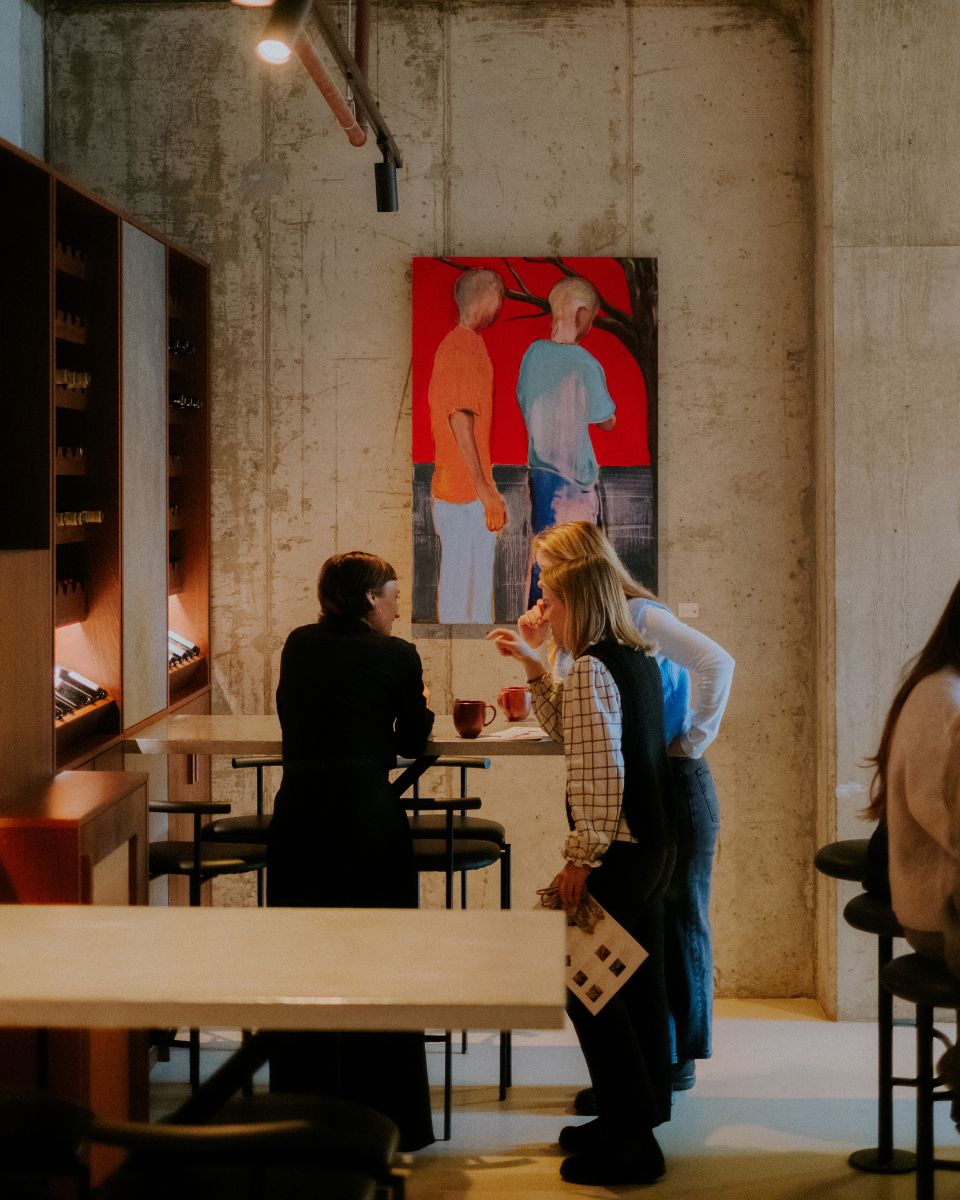 Visitors talking in front of an original George Marrington painting during the Blurred Visions exhibition for the homepage What's New section.