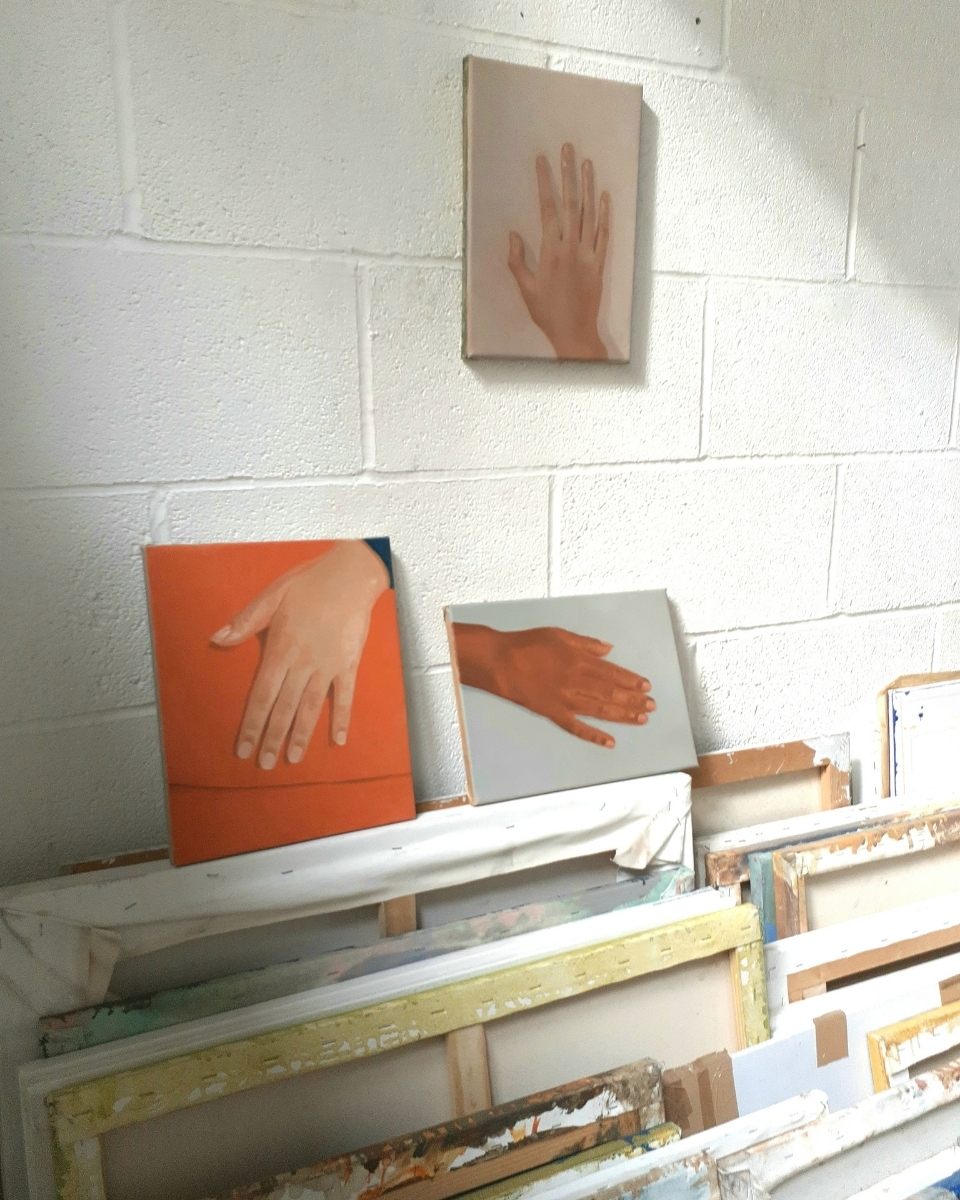 Studio detail featuring three contemporary hand study paintings by Brendan Lancaster at Partnership Editions.