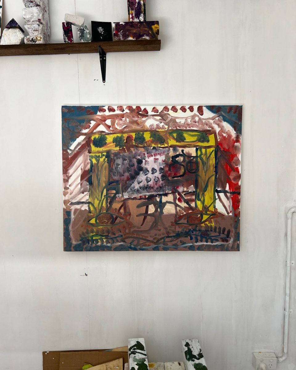 An original oil painting by Darcy McCrae hanging on a white studio wall during production.