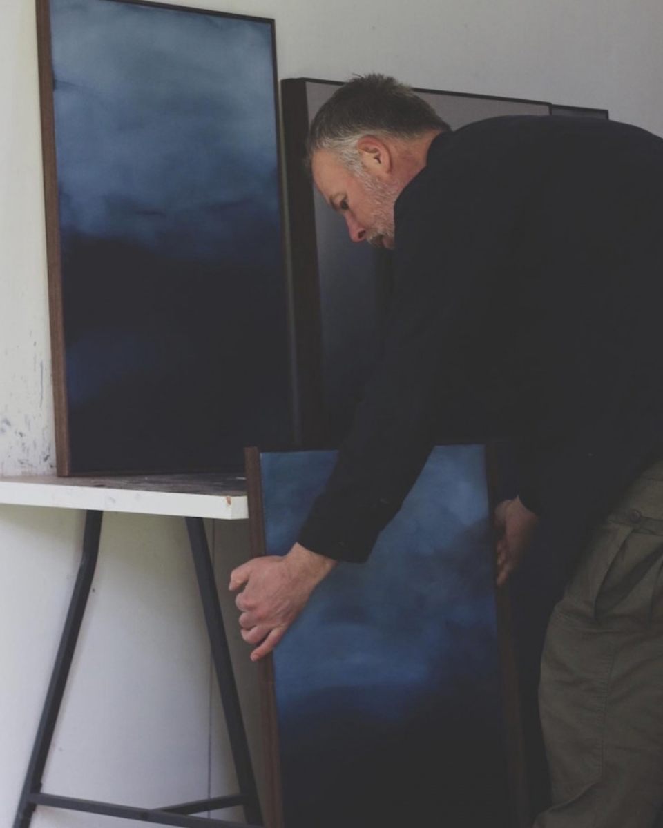 Carousel image of artist David Hardy arranging a contemporary framed abstract painting in his West Wales studio for Partnership Editions.