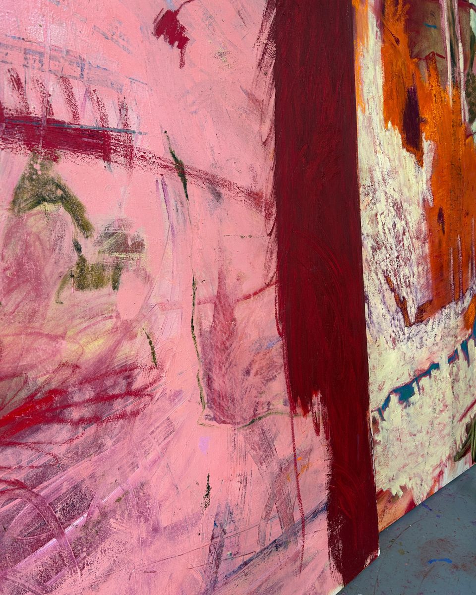 Close-up detail of dynamic brushstrokes, pastel marks, and rich burgundy paint layers on canvas by Ellie Walker.