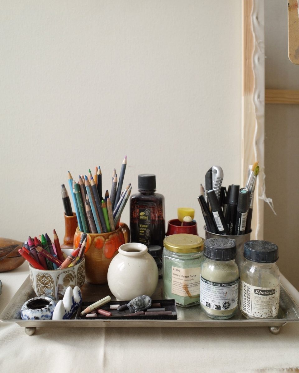 Close-up of Emilia Durka’s materials tray in her home studio, showcasing oil pastels, paints, and tools for Partnership Editions.