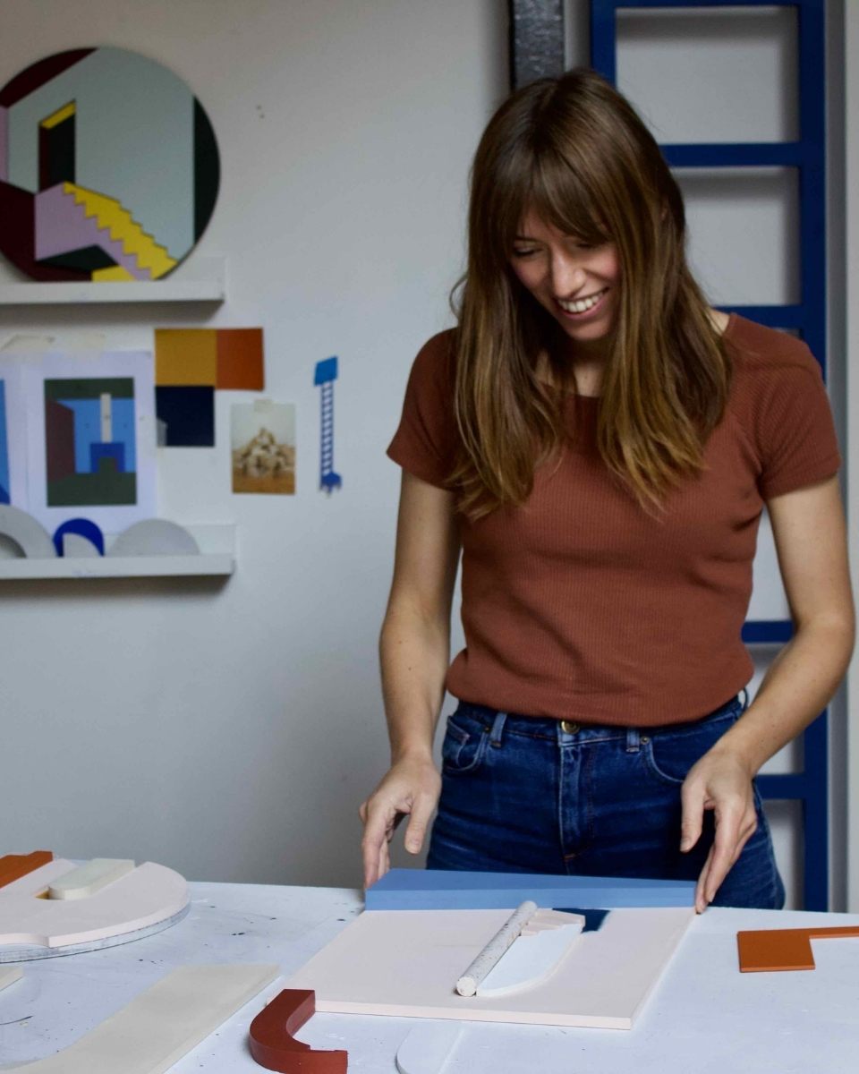 Artist Emily Forgot in her studio, hand-assembling a new architectural wood composition for Partnership Editions.