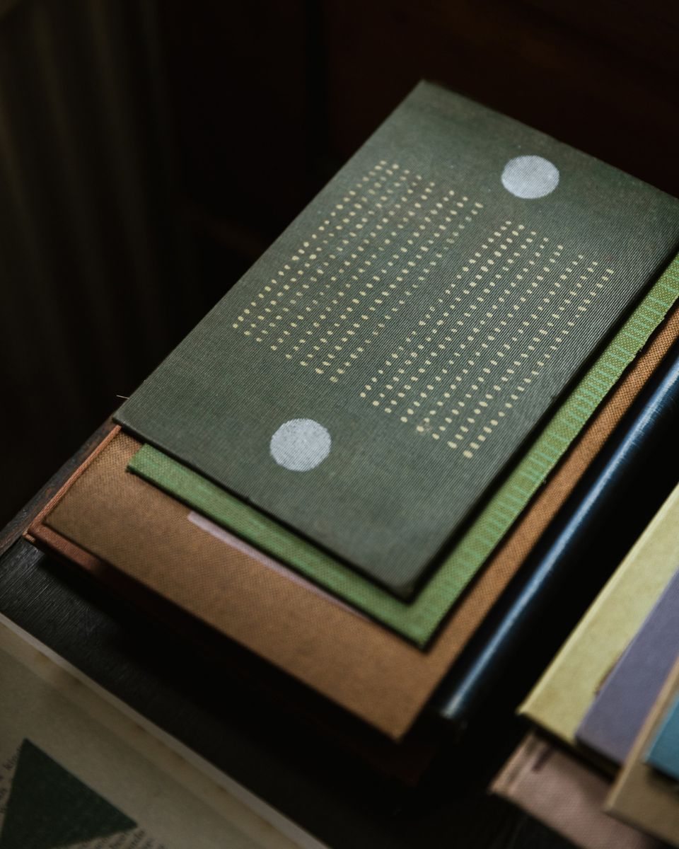 Close-up view of multiple colourful, abstract graphic art prints stacked on top of each other.