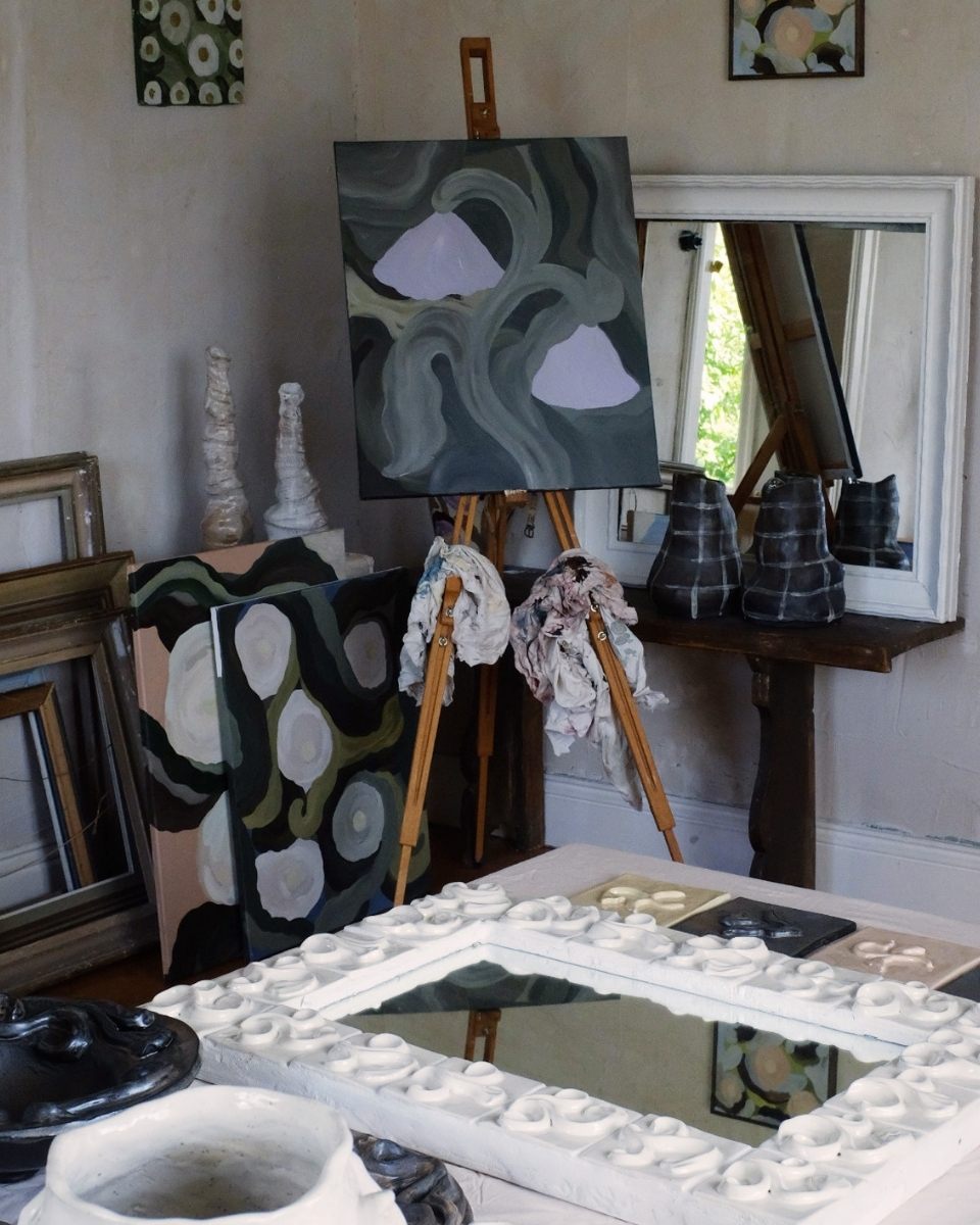 Studio shot featuring a painting on an easel alongside finished ceramic tiles in Fanny Schultz’s artist studio for Partnership Editions.