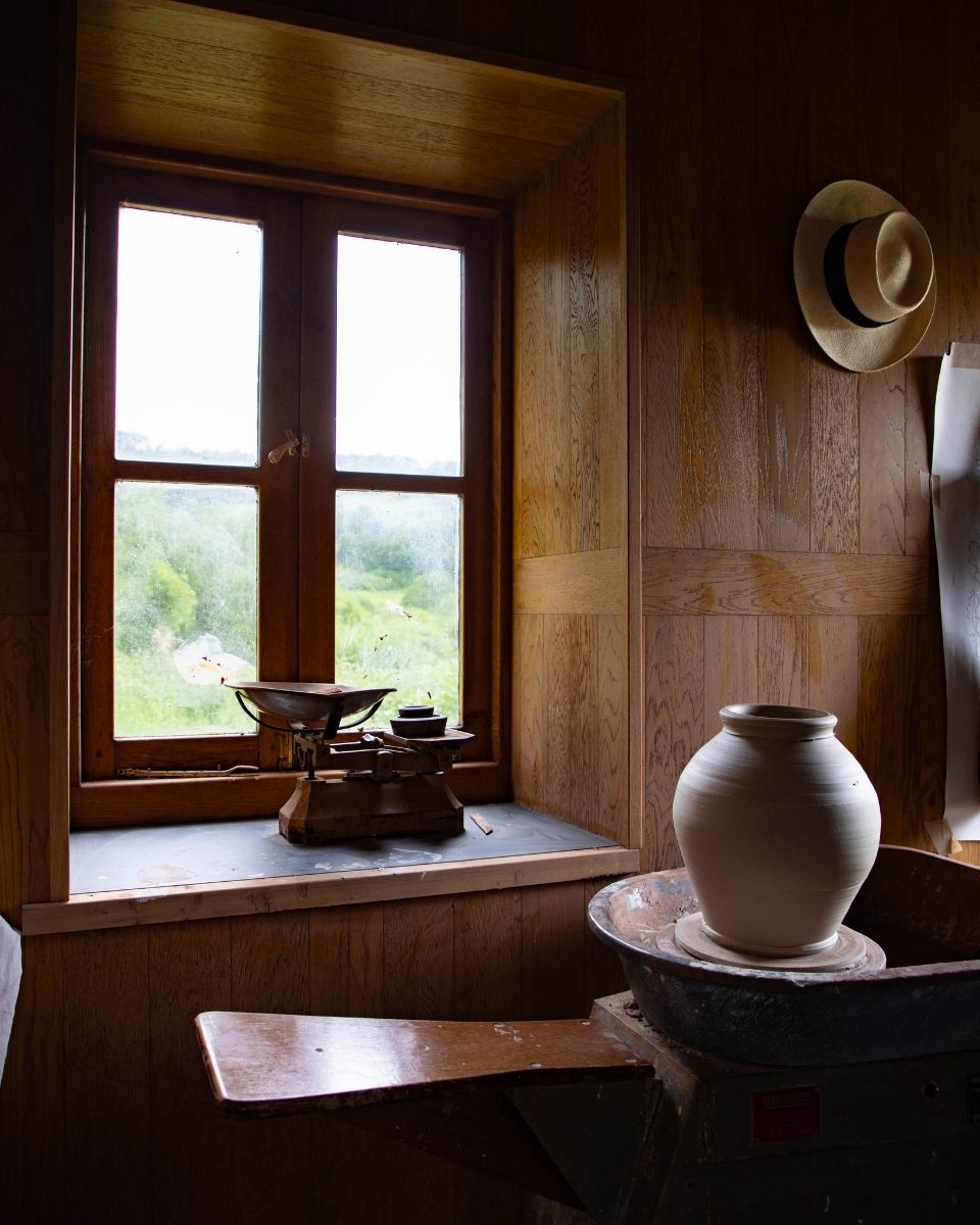 A work-in-progress stoneware clay vase being shaped on a pottery throwing wheel in Freyja Lee's studio.