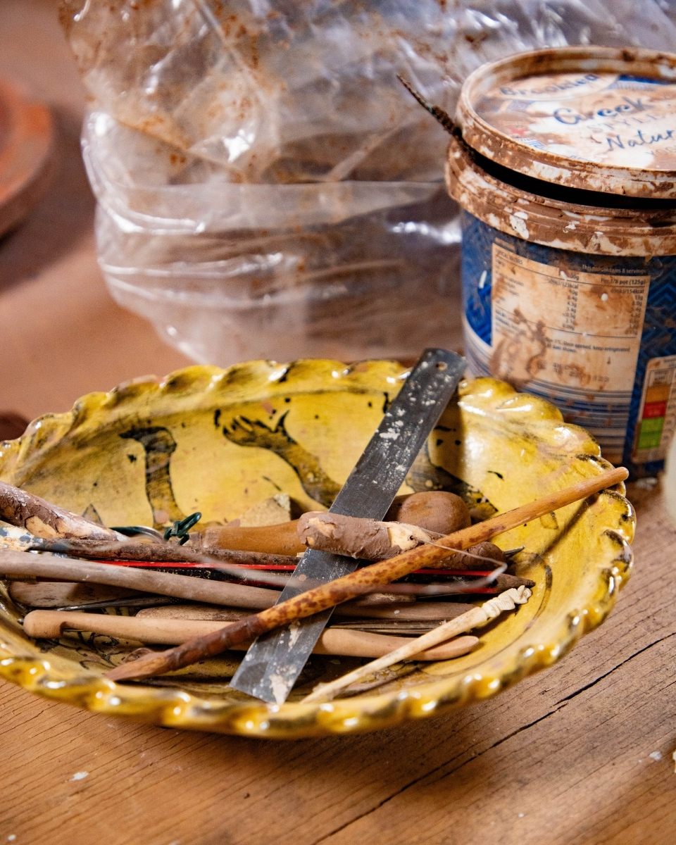 Close-up image of sgraffito tools and raw earthenware clay used by Freyja Lee in her ceramic studio for Partnership Editions.