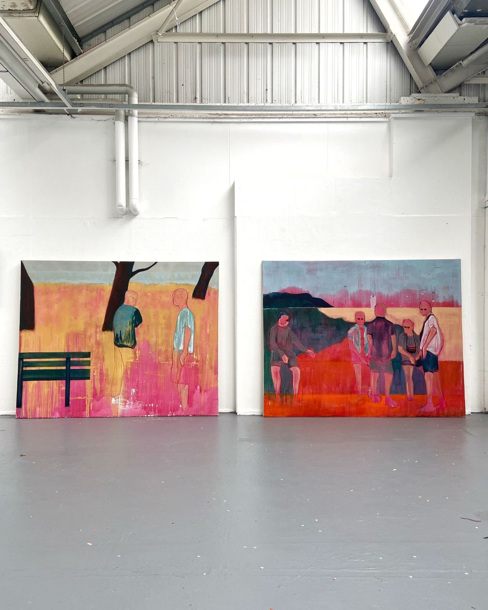 Two large figurative canvas paintings by artist George Marrington displayed inside a wide studio space.