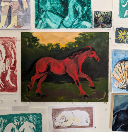 Horse gallops through a field