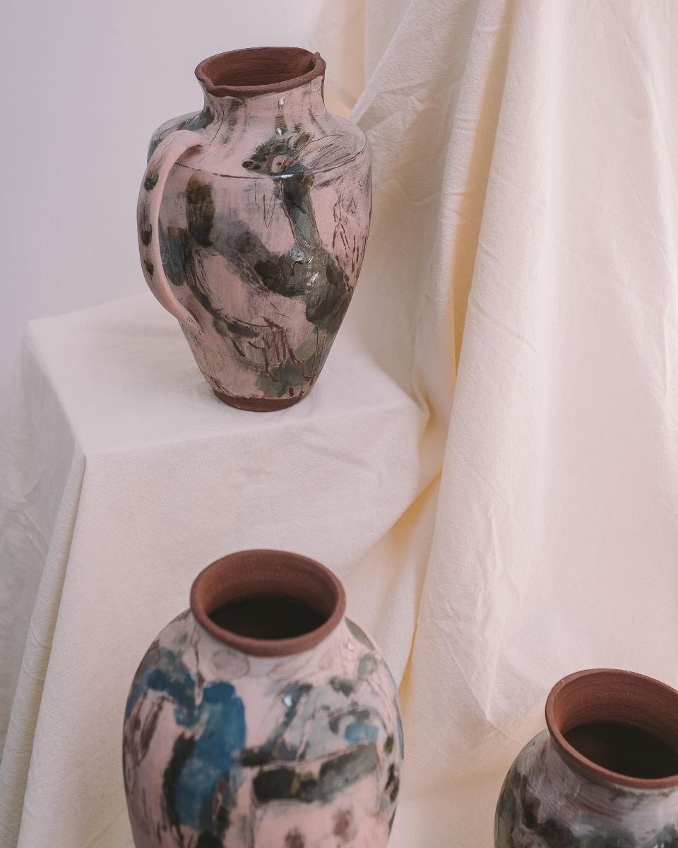 Imogen Richards’ studio display featuring finished hand-painted ceramic vases on a fabric-covered plinth for Partnership Editions.