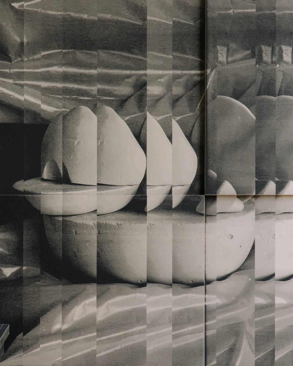 Close-up of a segmented black and white print by Ines Fernandez de Cordova, featuring collaged grids and graphic vertical cuts in her studio.