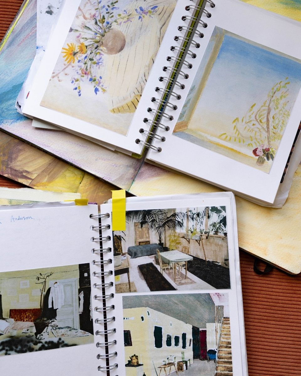 Inside Isabel Garfield’s notebooks, showcasing a curated collection of inspiration images and reference sketches in her studio.