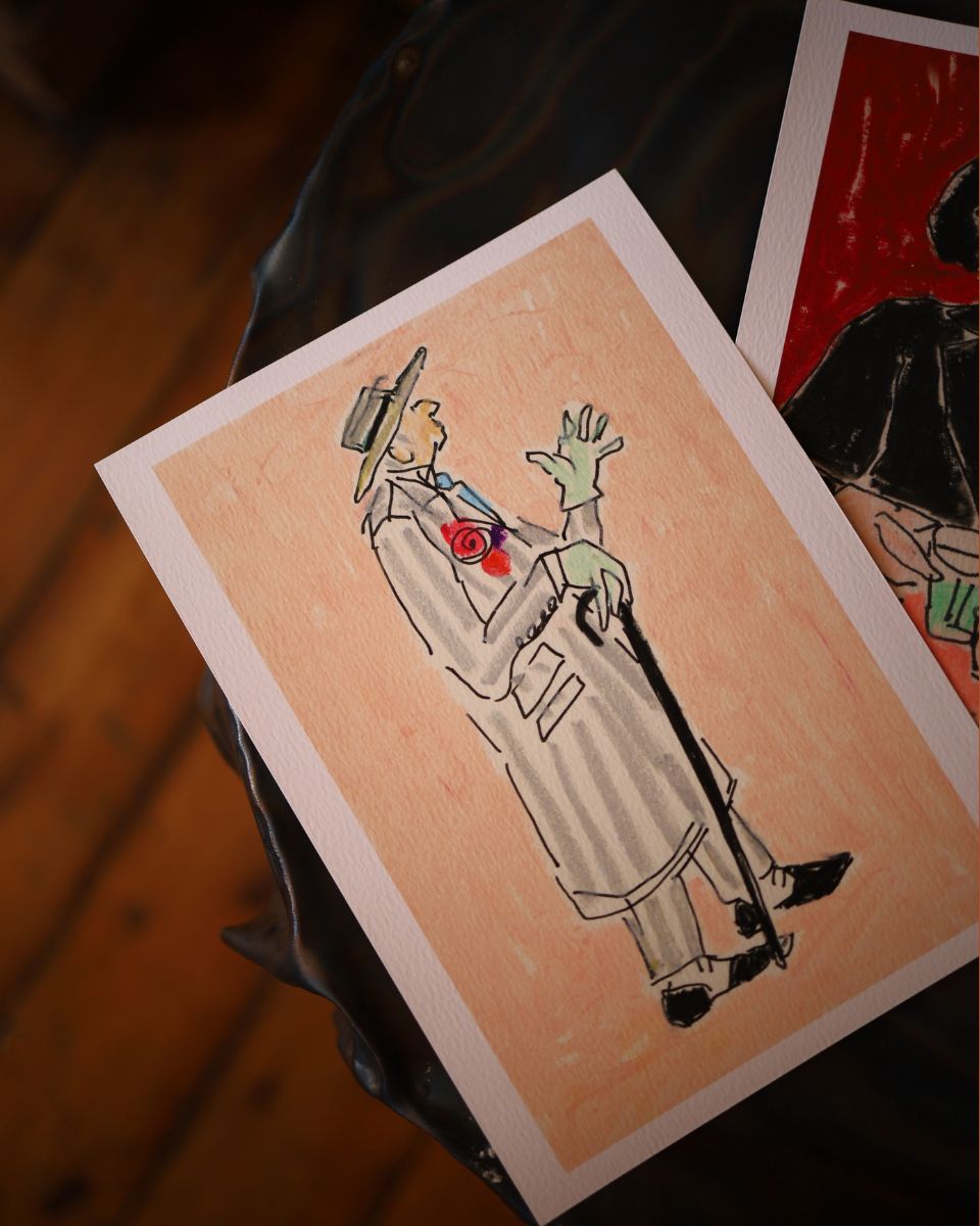 Close-up of an original ink and oil pastel illustration by Isabella Cotier featuring a stylish character in a trench coat holding a walking cane.