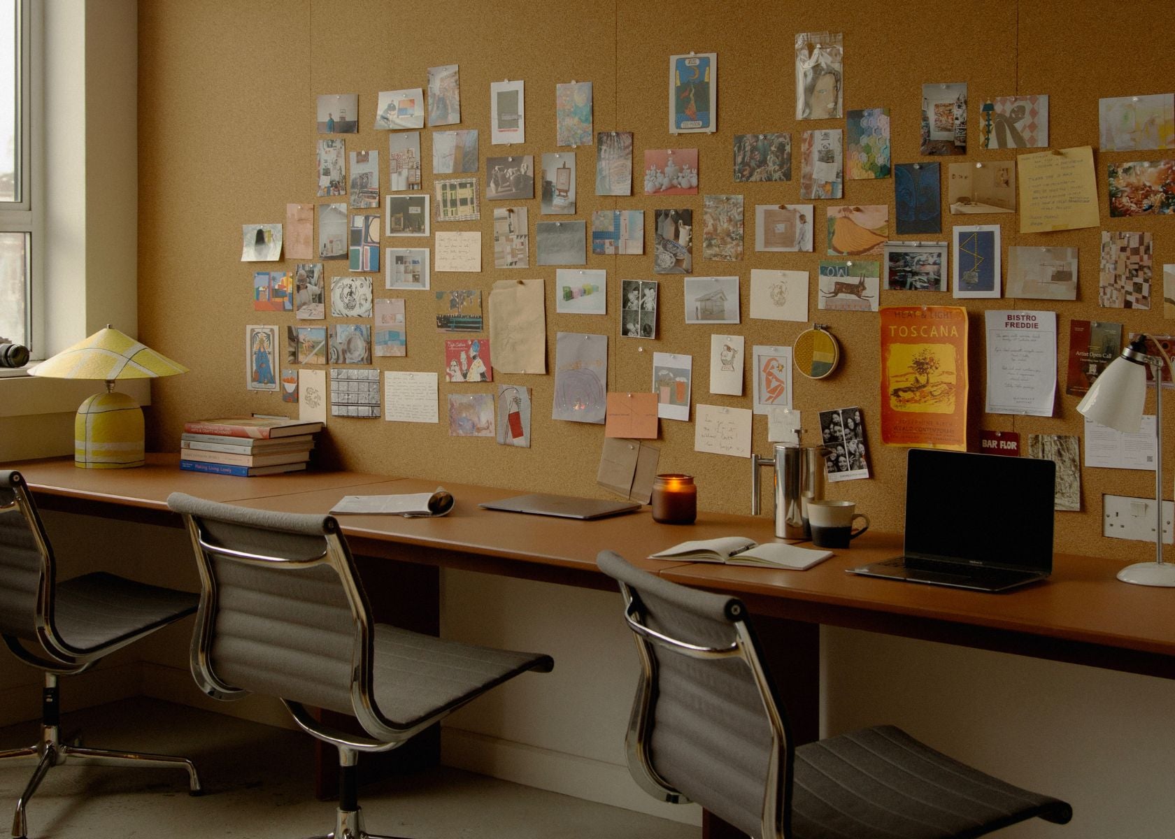 The Partnership Editions studio desk and gallery wall, showcasing our creative office for career opportunities.
