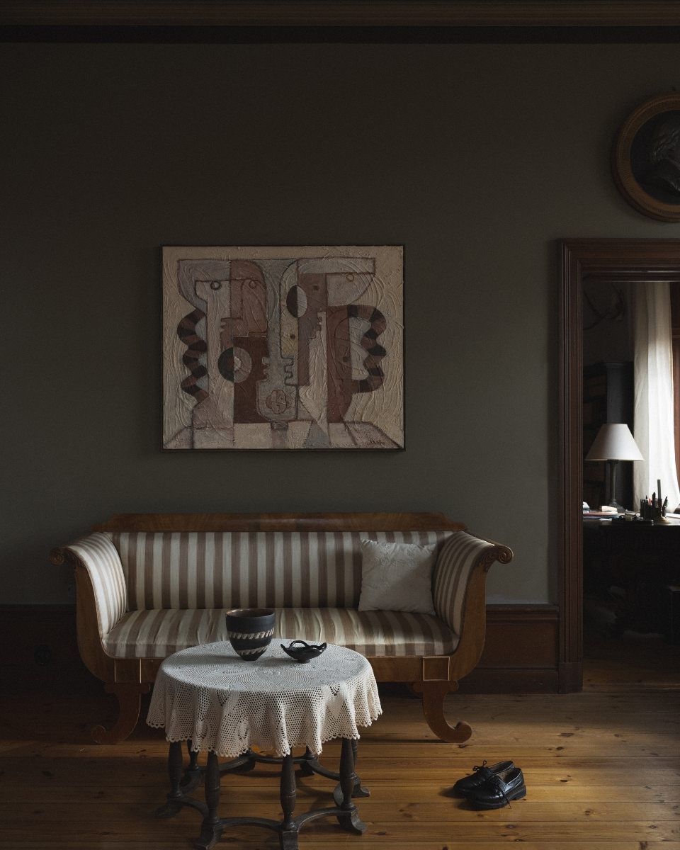 Styled interior shot of a mounted Josefin Tolstoy abstract painting displayed in her contemporary living room for Partnership Editions.
