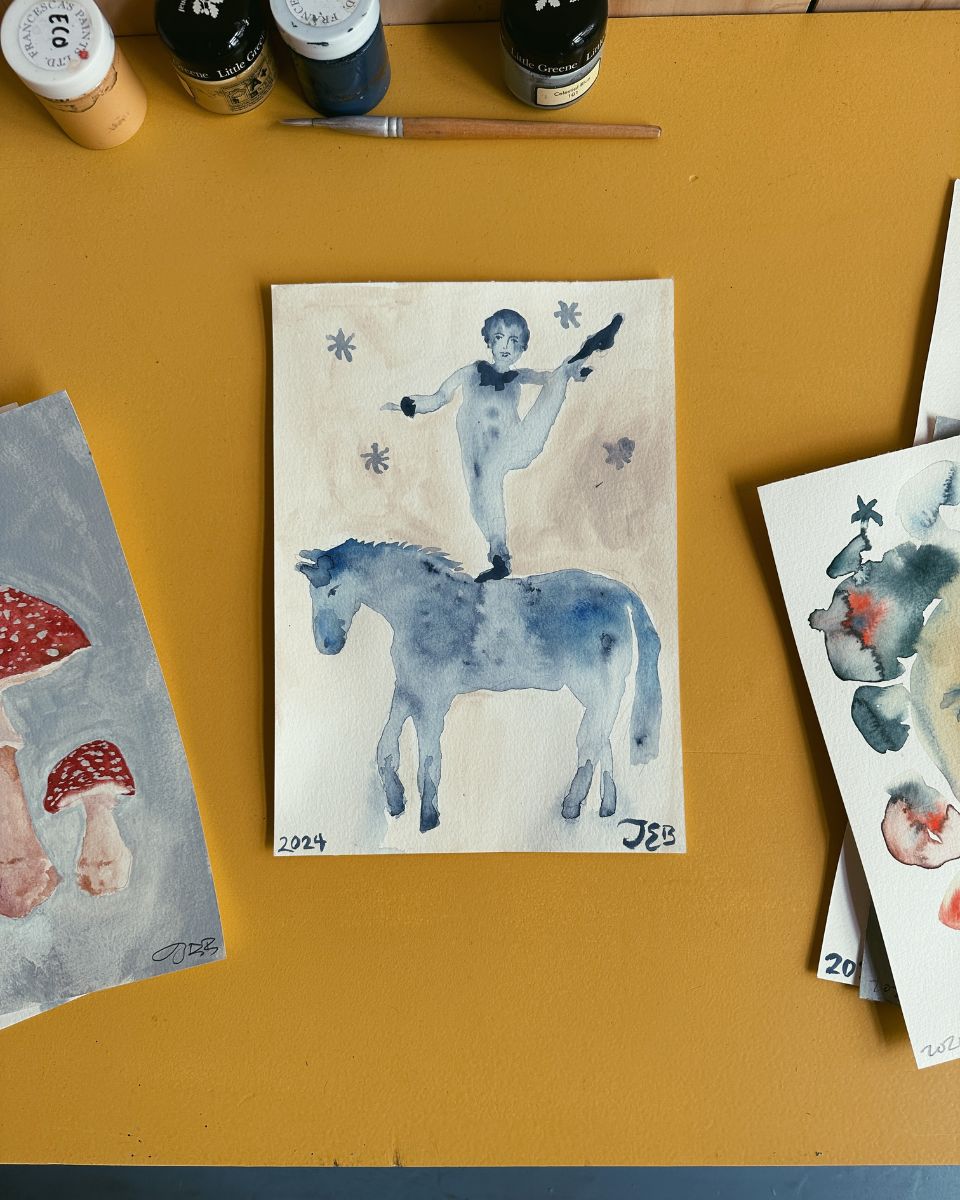 Julianna Byrne watercolour of a clown on a horse in her studio for the November Drop 2024 at Partnership Editions.