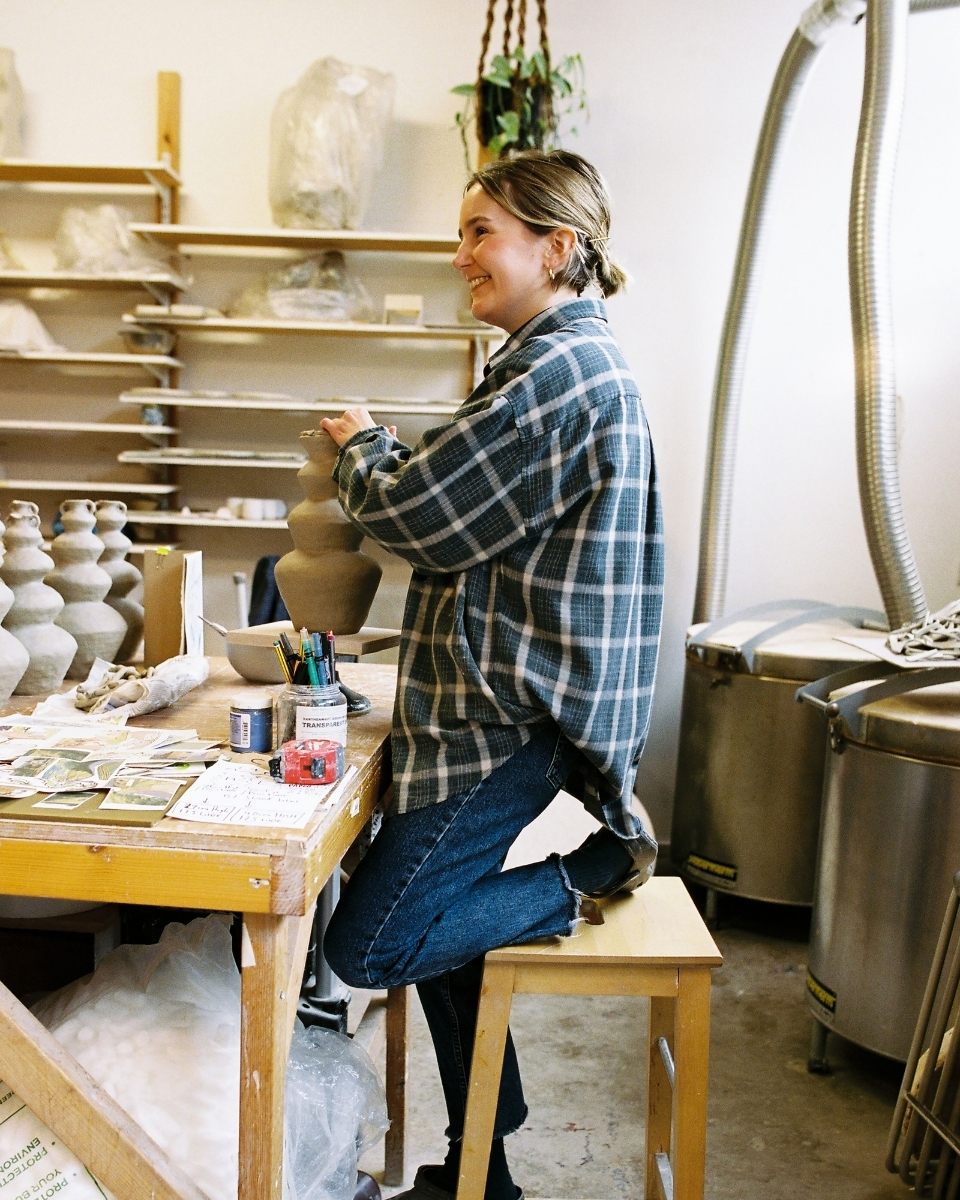 Artist Katie Moore in her studio, hand-building a contemporary clay relief sculpture for Partnership Editions.