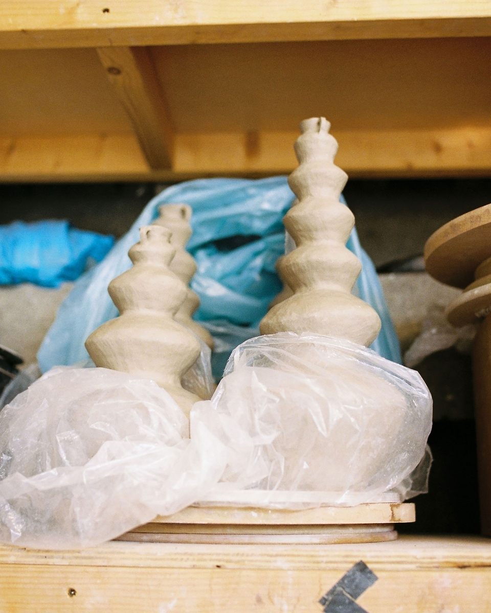 A collection of Katie Moore’s raw clay sculptures drying in her studio, ready to be fired in the kiln for Partnership Editions.