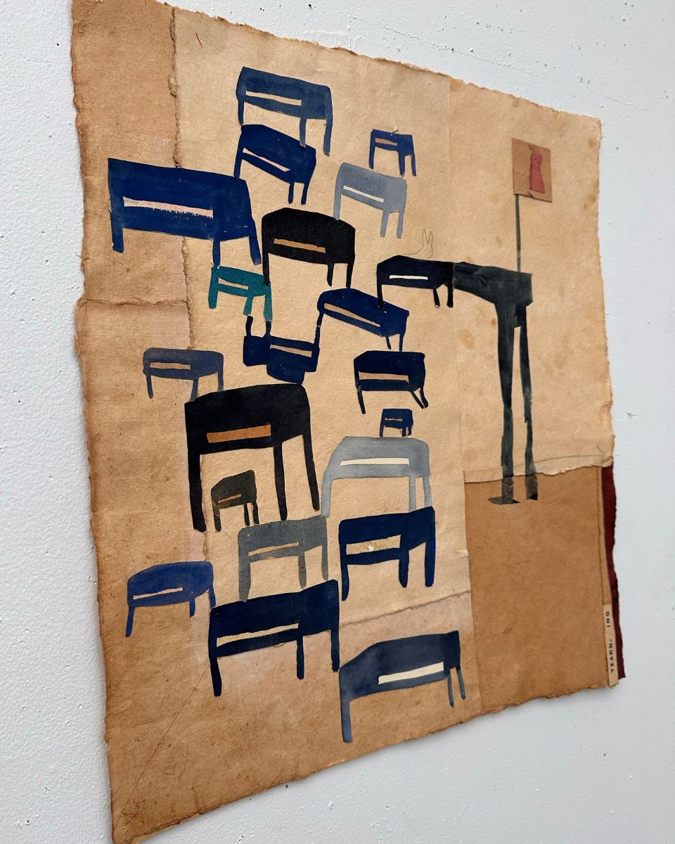 Close-up of a mixed media collage with painted blue and black chairs on aged handmade paper by Kelly Popoff.