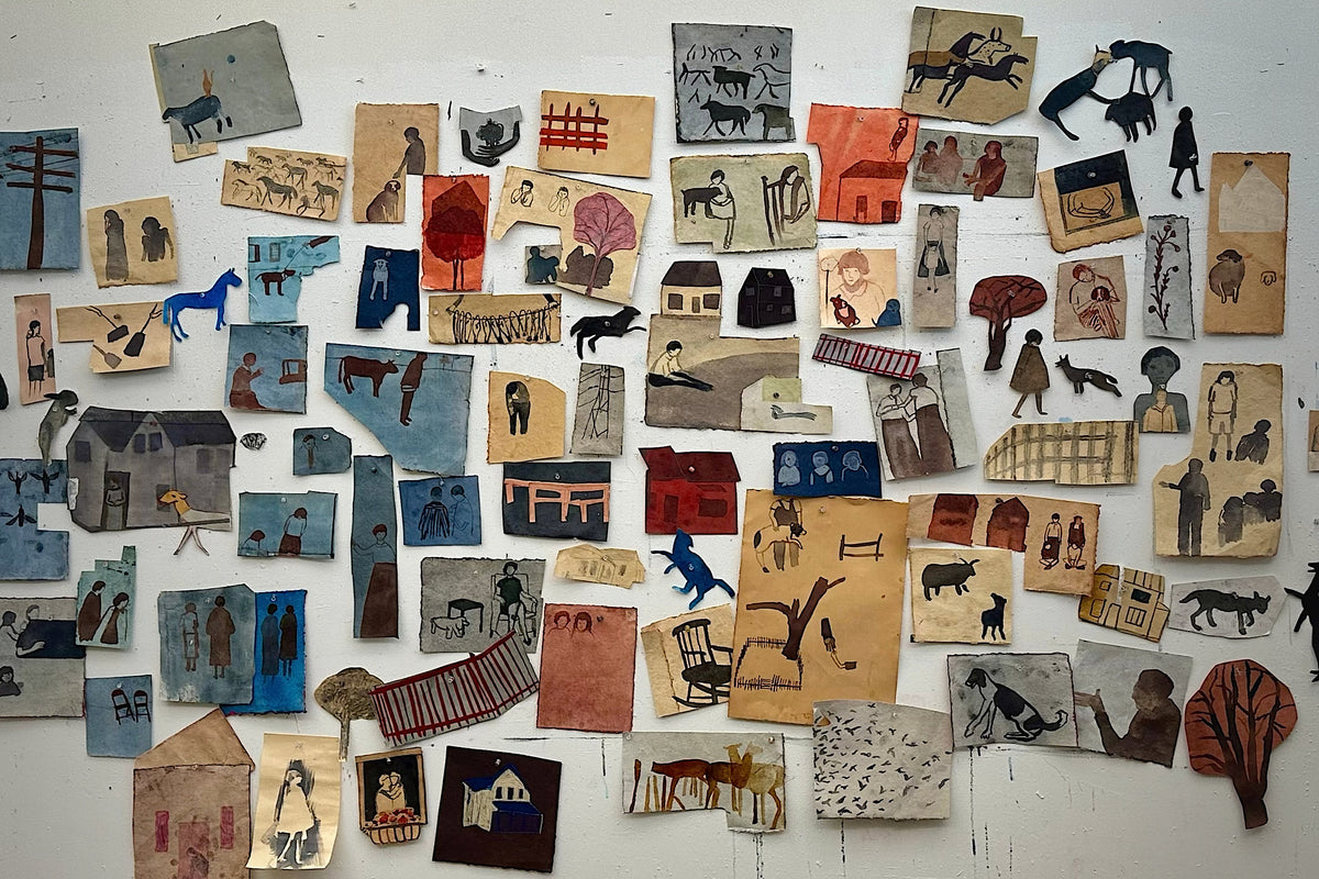 Panoramic studio wall view filled with pinned figurative paper works, painted animals, and small house collages by Kelly Popoff.