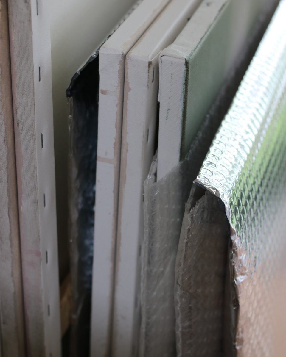 Close-up of canvas edges loosely packed in bubble wrap envelopes for Partnership Editions.