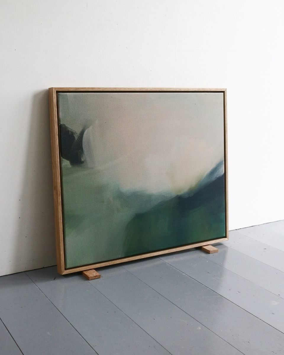 A professional wood framed Lisa Hardy painting displayed in a minimalist studio corner for Partnership Editions.
