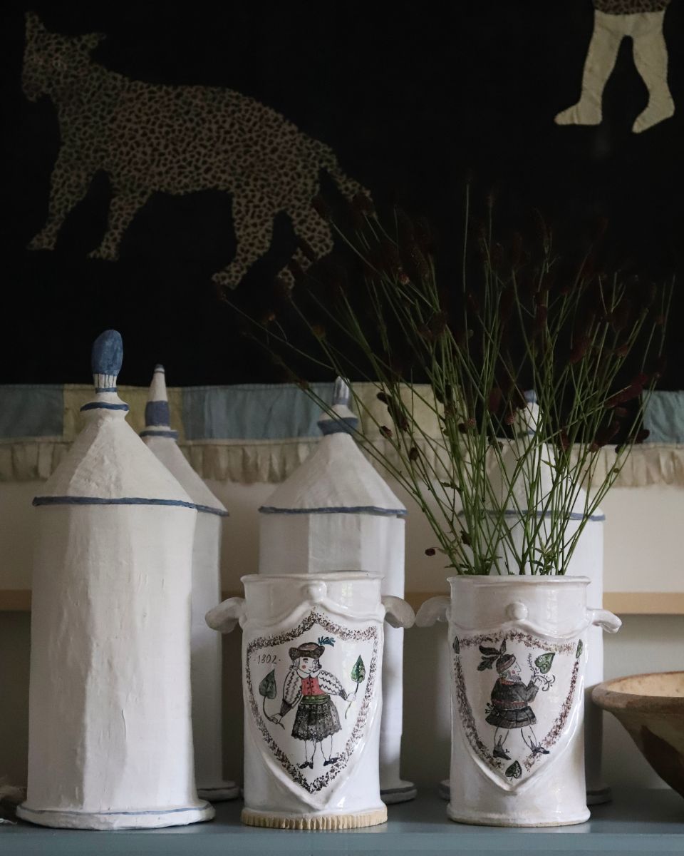 Lisa Sandner illustrated ceramic vase filled with dried botanicals alongside handcrafted vessels featured in the What's New homepage section for the September 2026 drop at Partnership Editions.
