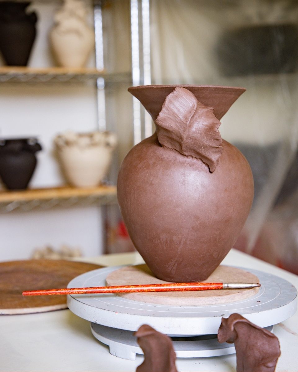 Close-up of a raw clay vase by Lucy Whitford in its greenware state, ready for firing in her London studio for Partnership Editions.