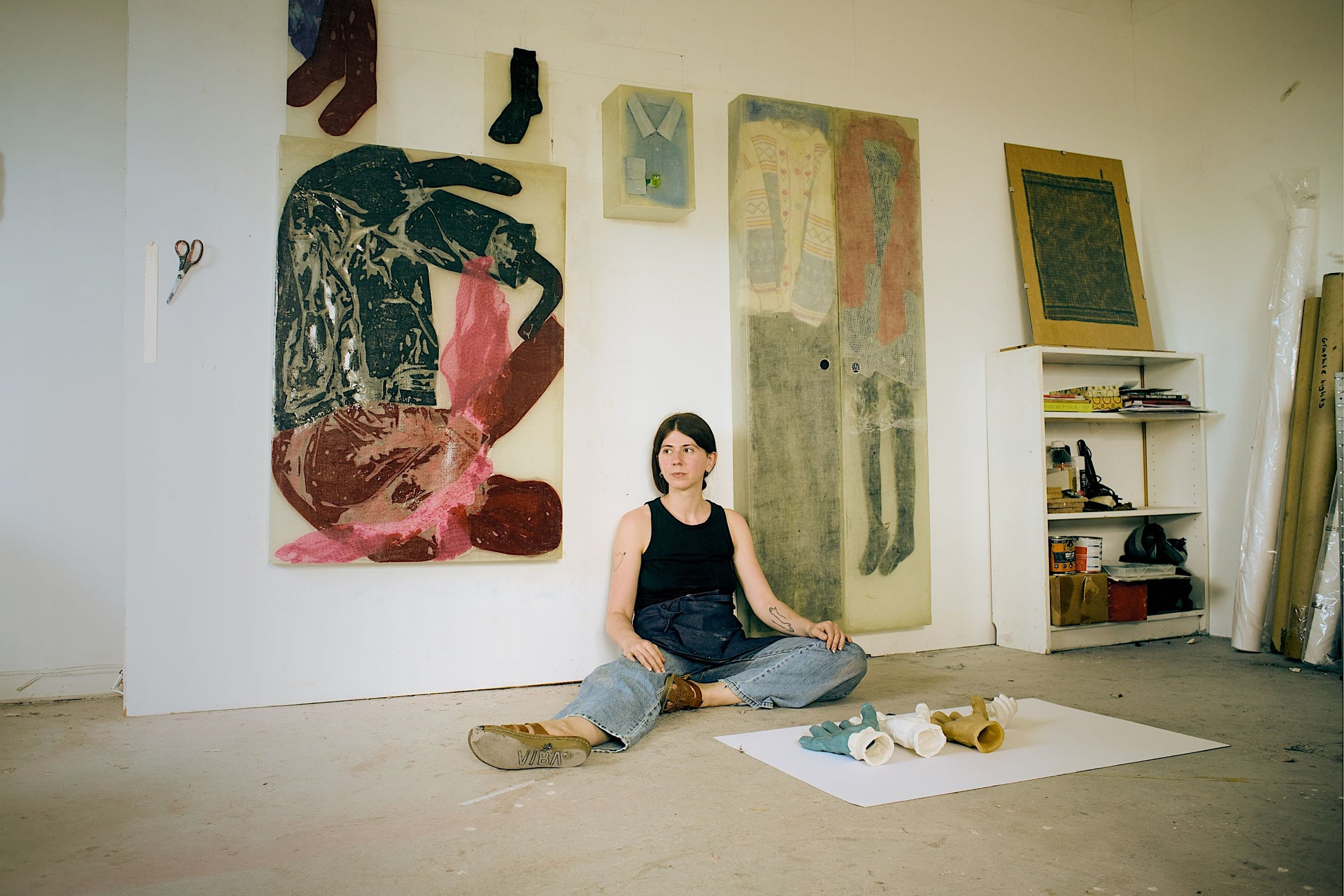 Mae Nicolaou in her studio in front of her large-scale sculptural artworks blending printmaking and sculpture.