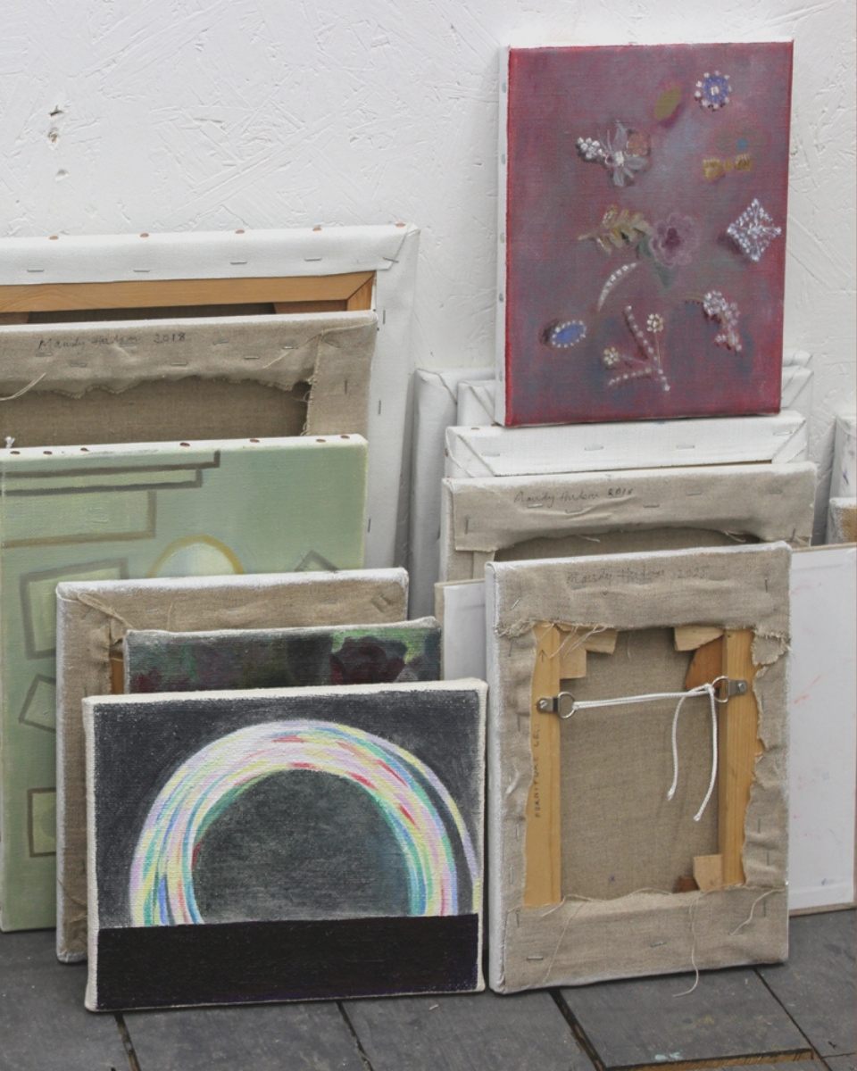 Close-up detail of oil on canvas paintings leaning against a studio wall, showcasing Mandy Hudson’s subtle colour transitions.