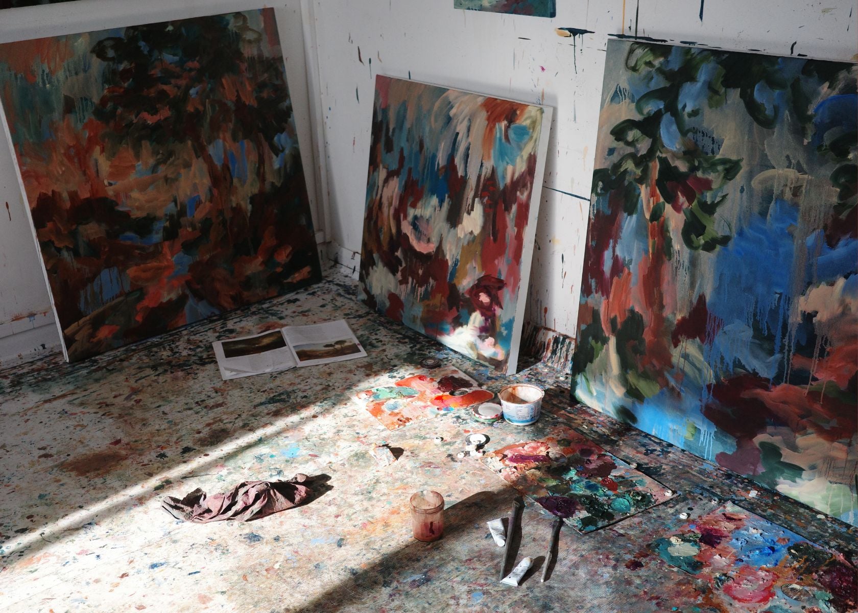 A promotional homepage banner for the Partnership Editions Artist Open Call 2026, showcasing vibrant, layered abstract landscape paintings by artist Mary West
