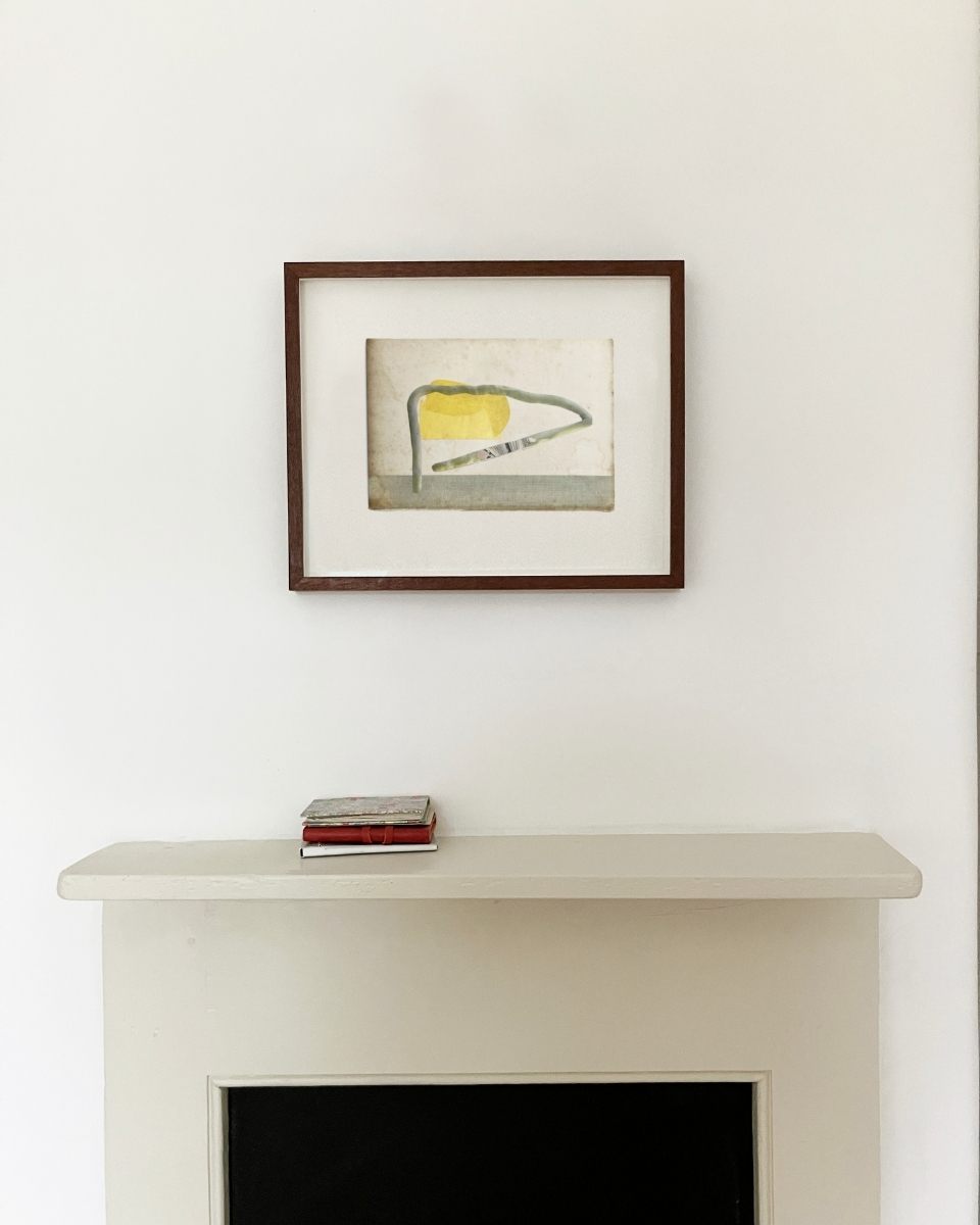A framed original artwork by Matthew Richardson mounted above a fireplace, demonstrating how his minimalist aesthetic fits a modern home.