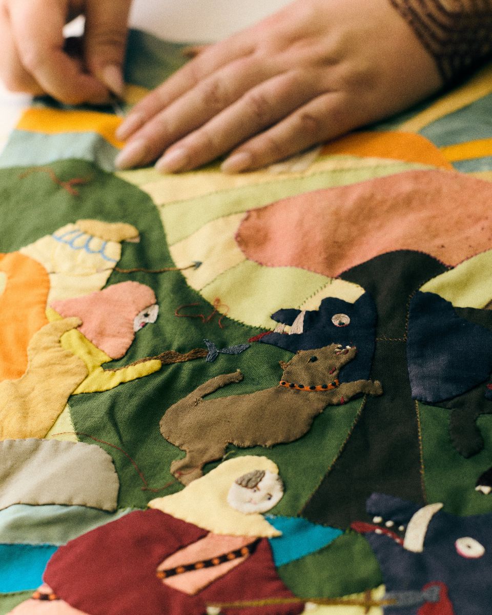 Macro close-up detail showcasing the intricate stitching and texture of Molly Lester's embroidery art.