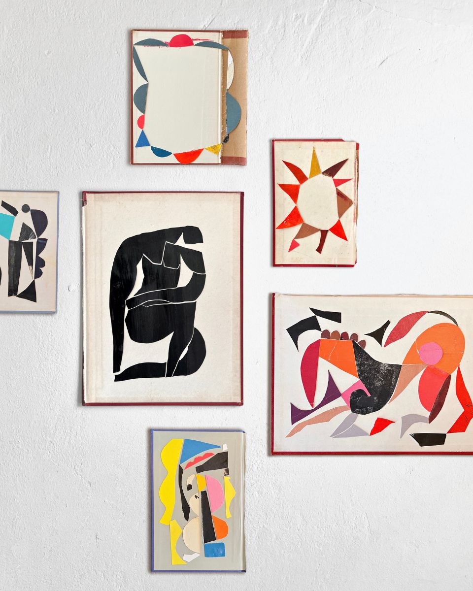 Detail shot of Nathan Isaac’s studio gallery wall, a curated arrangement of minimalist paper constructions and abstract colour studies.