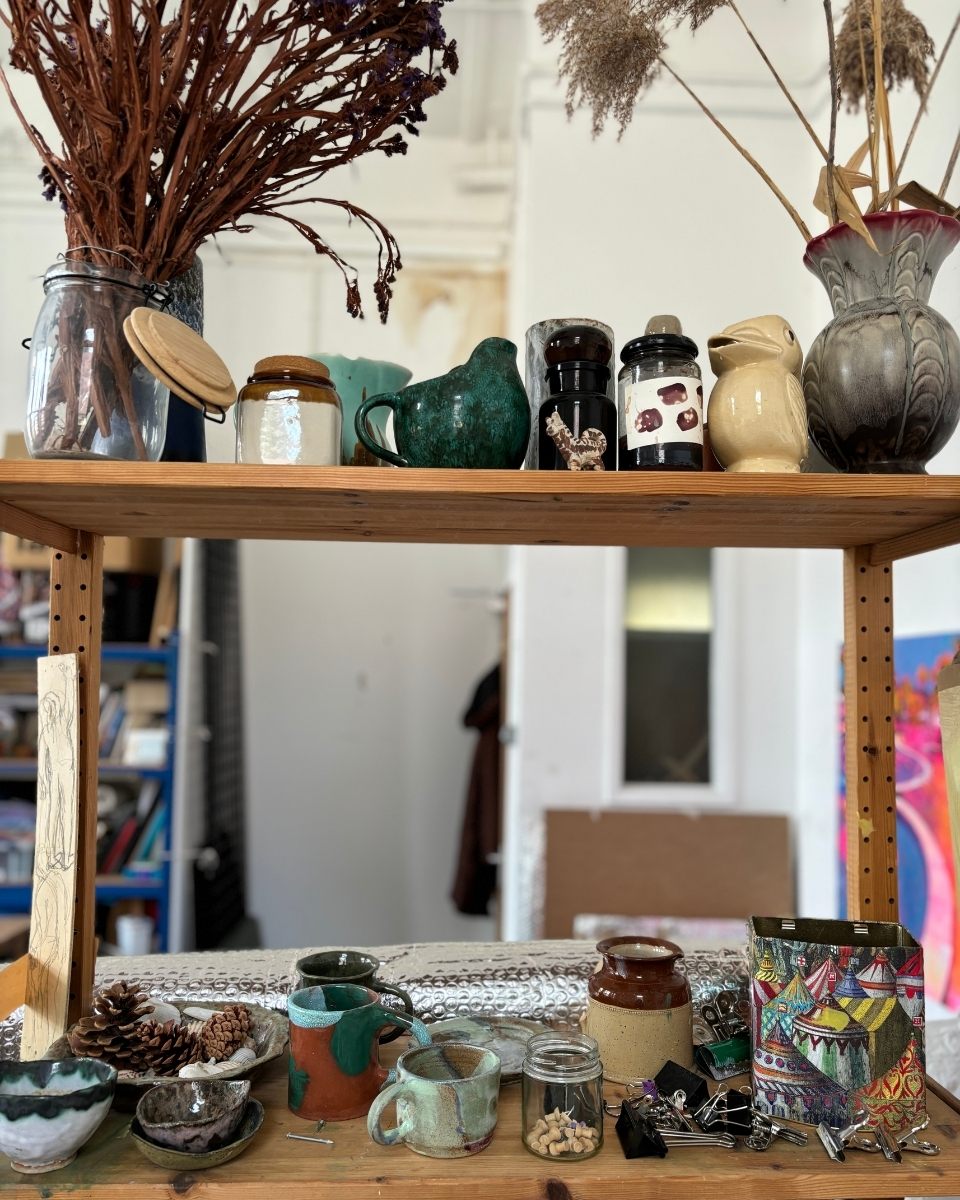 Detail shot of Nikki Gardham’s studio shelf, curated with ceramic trinkets and found objects that inform her art.