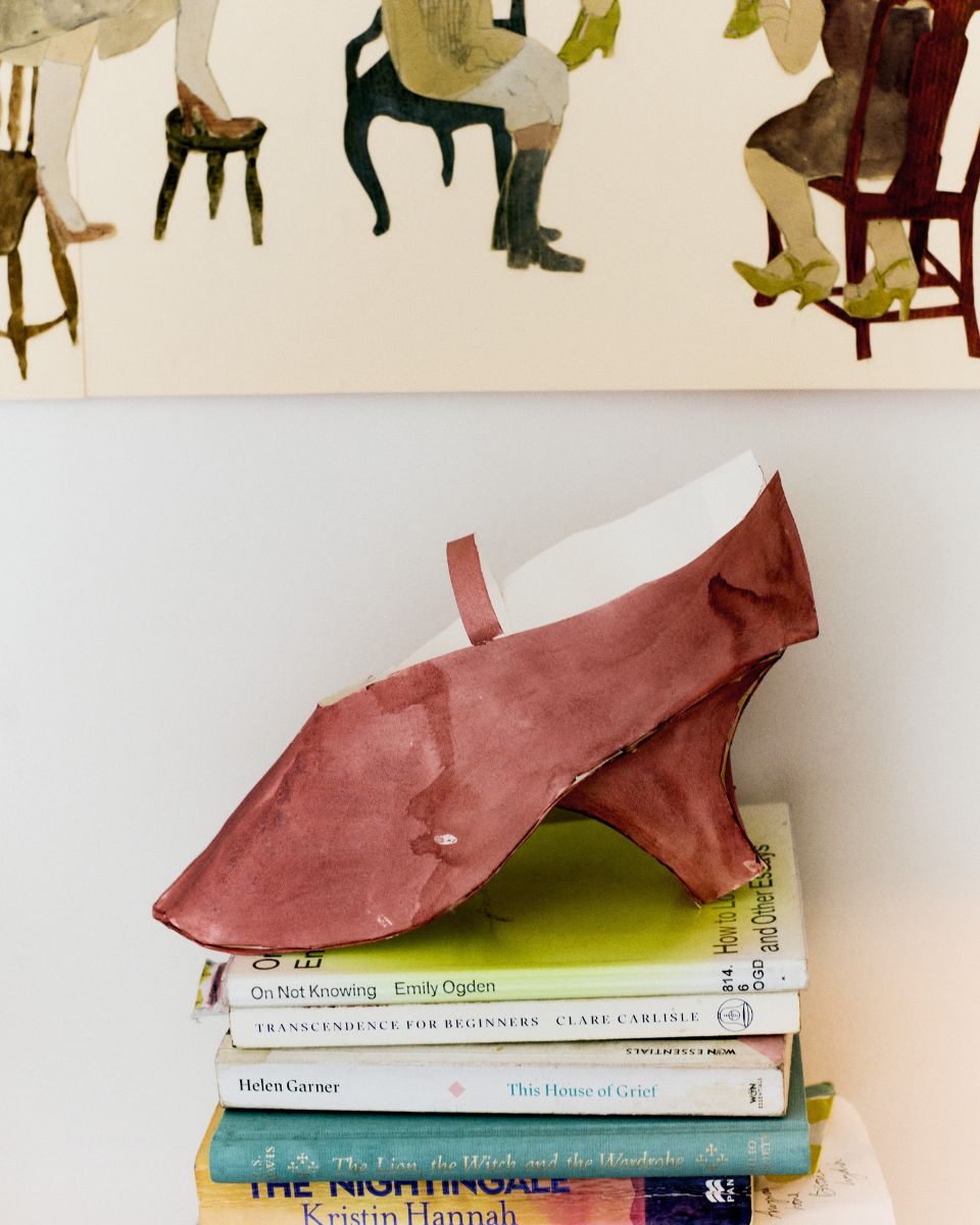 A delicate three-dimensional paper shoe sculpture handcrafted by artist Phoebe Howard.