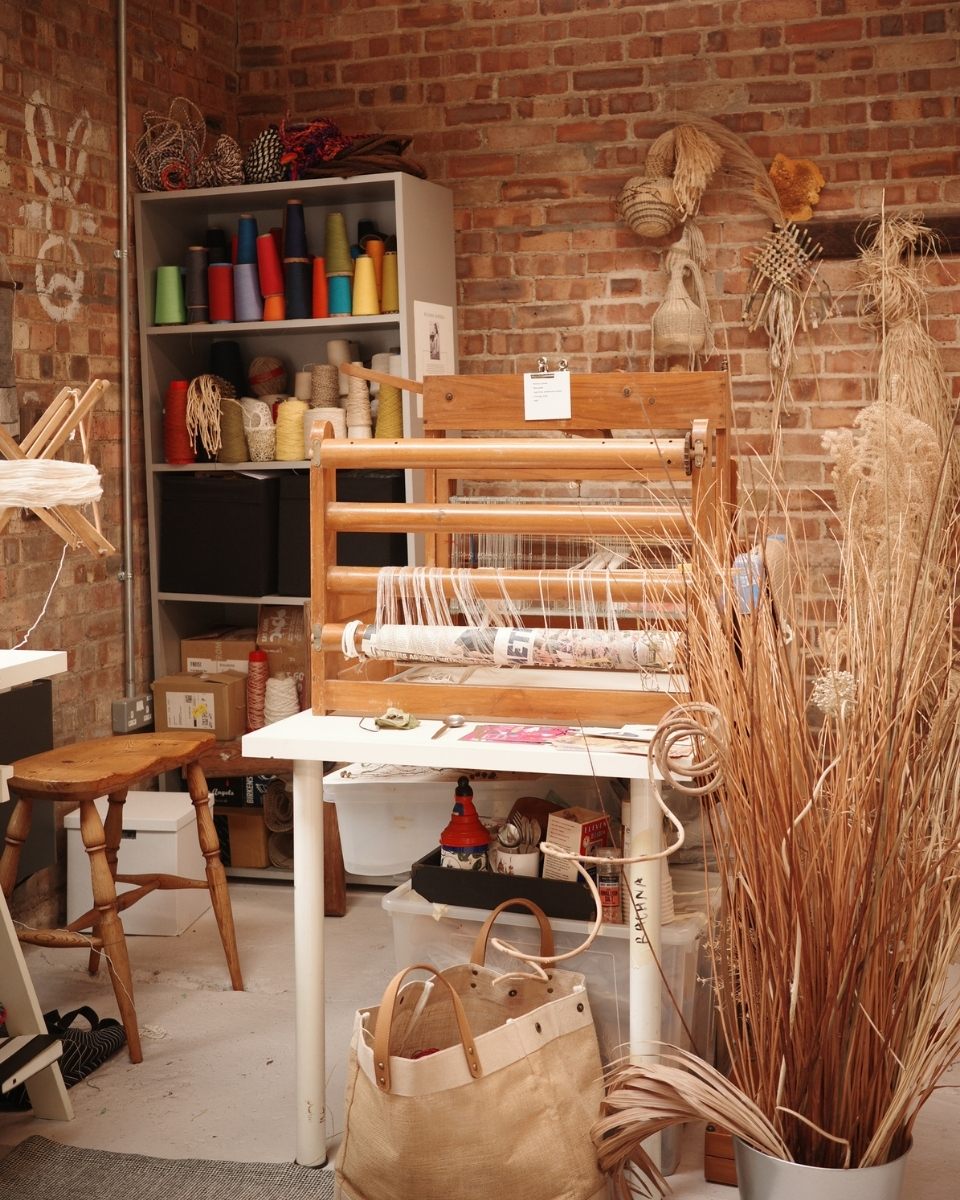 Rachna Garodia’s West London studio featuring her traditional weaving loom and a curated shelf of heritage threads and natural fibers.