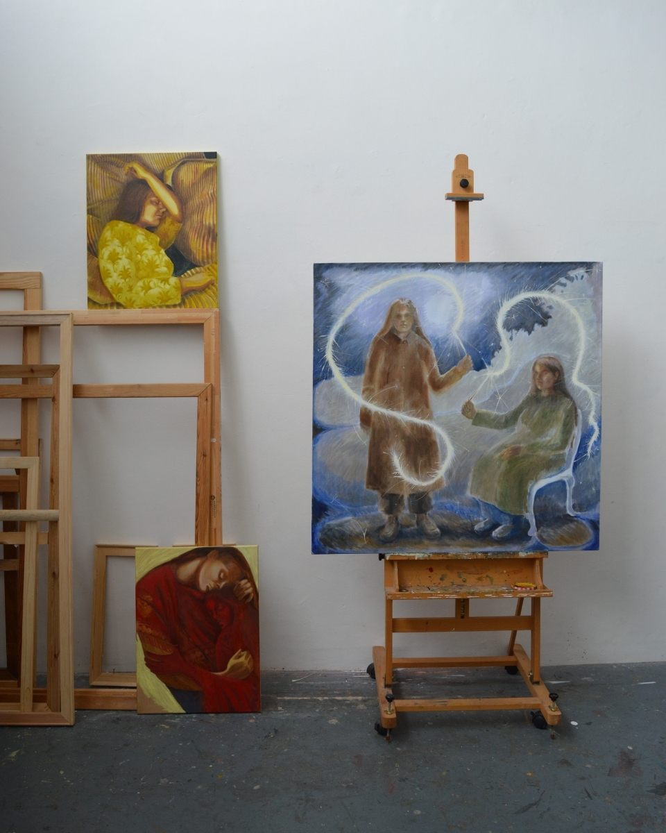 A curated area of Robyn Packham’s studio featuring a large-scale work on an easel flanked by two smaller study paintings.